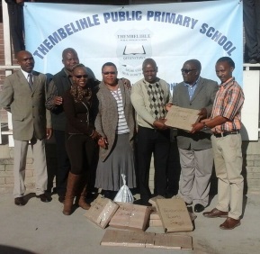 Teachers from Tembelihle Public Primary School, from left, Morris Rani, Thembi Nofemela, Nomathamsanqa Tsoteetsi, Lindiwe Katywa, Mabheka Mafuxawana, Mfundo Mxoli received windows donated by local businessman Minanwe Dubase 