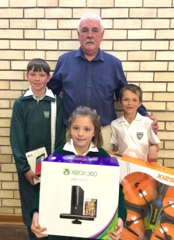 Laerskool Hangklip principal Jannie Pretorius with the pupils who sold the most tickets for the school's lucky draw, from left, JJ Fouche, Phillipa van Deventer and Rynard de Beer. The main prize of a boat trip was won by Danny Mulder