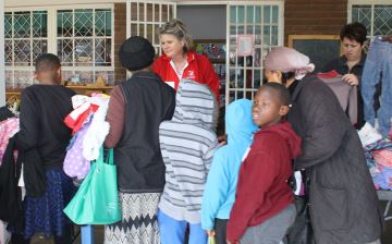STREET STORE: Mandy de Villiers and Alicia Els from Balmoral Pre-Primary School help residents choose items of clothing during the school's Street Store event on Saturday. Picture: BHONGO JACOB