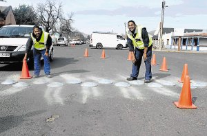 SLOWING MOTORISTS DOWN: Erecting the speed humps in Grey Street and Prince Alfred Street this week were Ivano Debruin, left, and Gregory Buys from Safety Xpress Stromberg Picture: BHONGO JACOB 